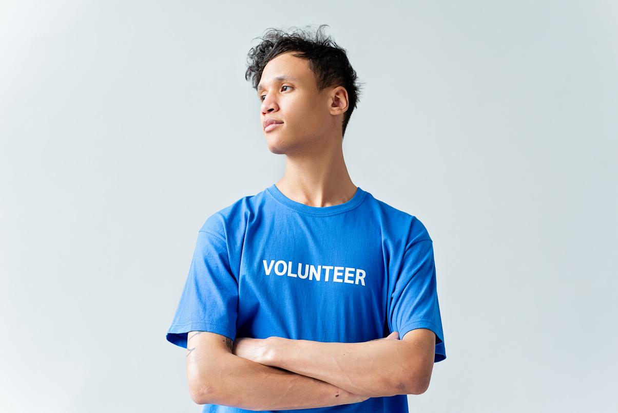 Man In Blue Shirt Standing With Arms Crossed